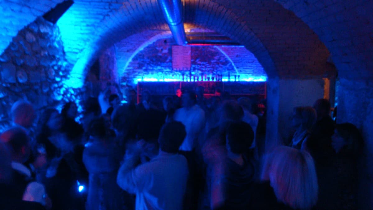 Feiernde Gäste in blauer Beleuchtung